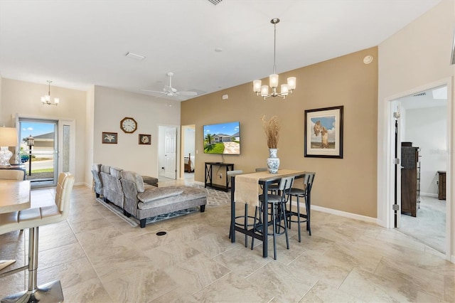 dining area featuring baseboards and ceiling fan with notable chandelier