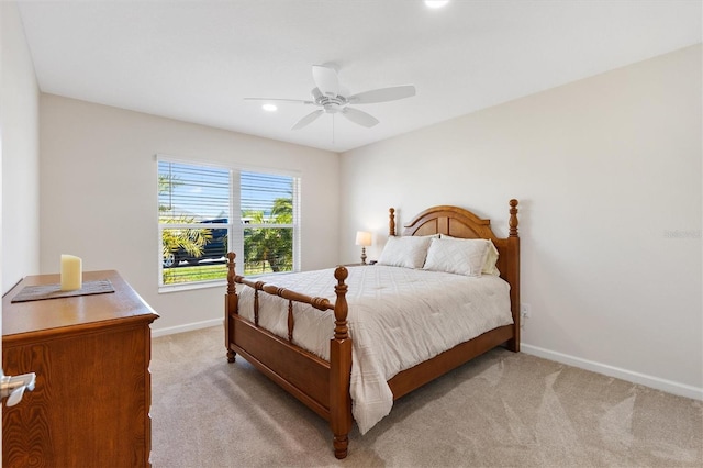 bedroom featuring recessed lighting, light colored carpet, baseboards, and ceiling fan