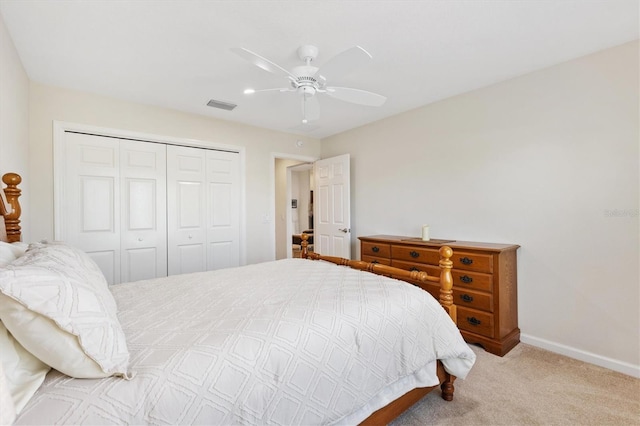 carpeted bedroom featuring baseboards, visible vents, a closet, and ceiling fan