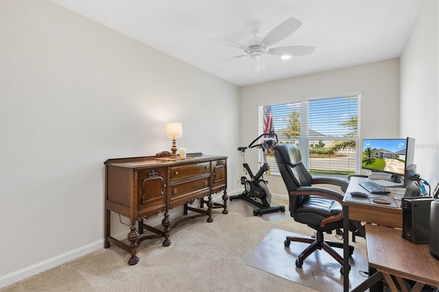 home office with light carpet, baseboards, and ceiling fan