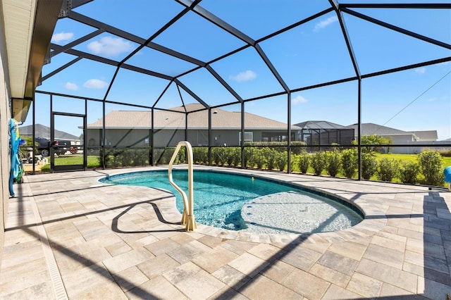 outdoor pool featuring glass enclosure and a patio area