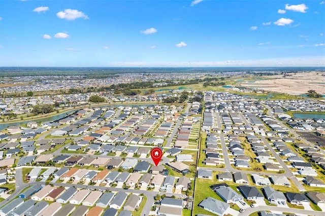 drone / aerial view featuring a residential view and a water view