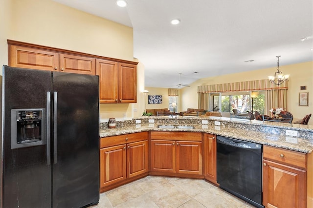 kitchen featuring a sink, brown cabinets, a notable chandelier, and black appliances