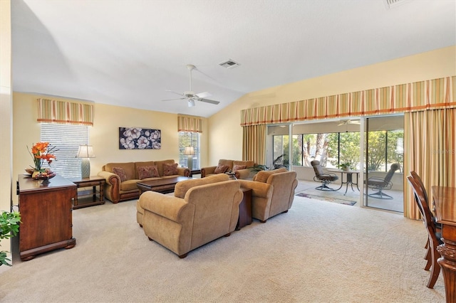 carpeted living area with visible vents, a ceiling fan, and lofted ceiling