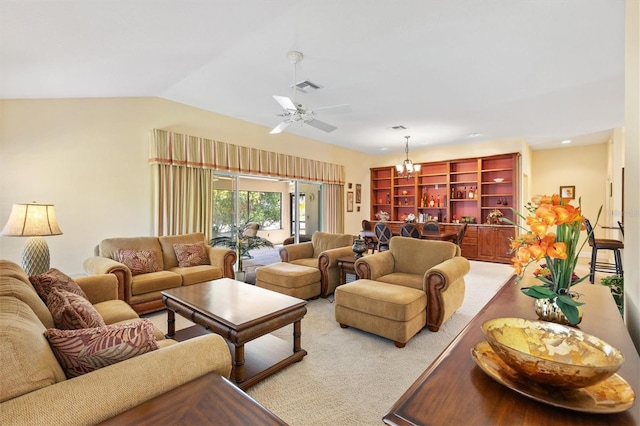 carpeted living room with visible vents, lofted ceiling, and ceiling fan with notable chandelier