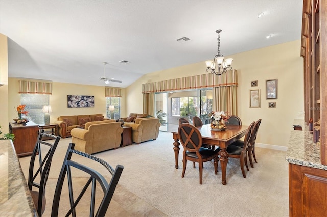 dining space featuring visible vents, light carpet, and vaulted ceiling