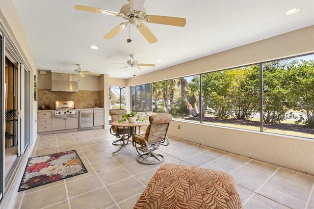 sunroom / solarium featuring ceiling fan