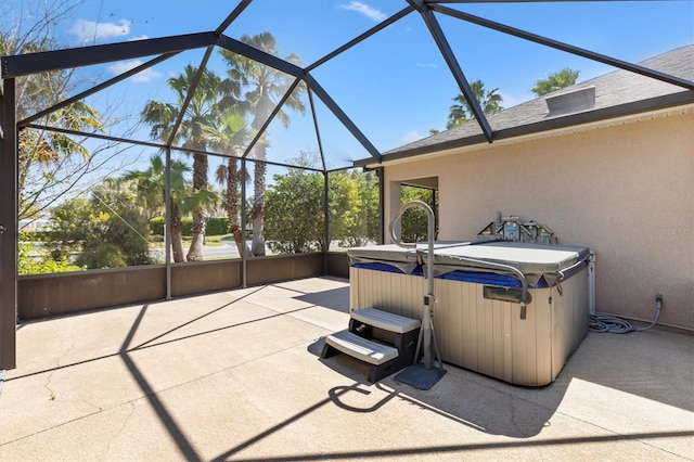 view of patio with a lanai and a hot tub