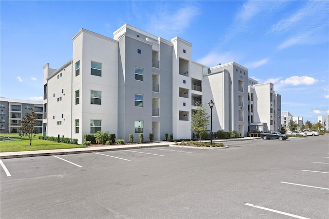 3180 Paradox Cir Unit 106, Kissimmee, FL 34746 - view of building exterior with uncovered parking