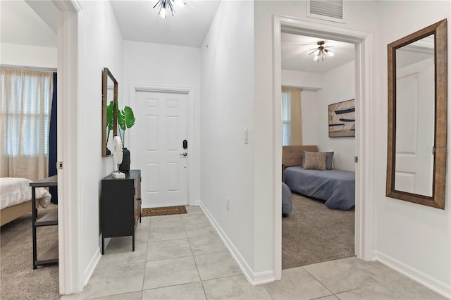 entrance foyer with light tile patterned floors, visible vents, and plenty of natural light