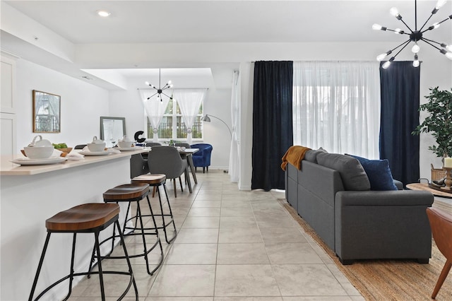 living room with light tile patterned flooring, recessed lighting, baseboards, and a chandelier