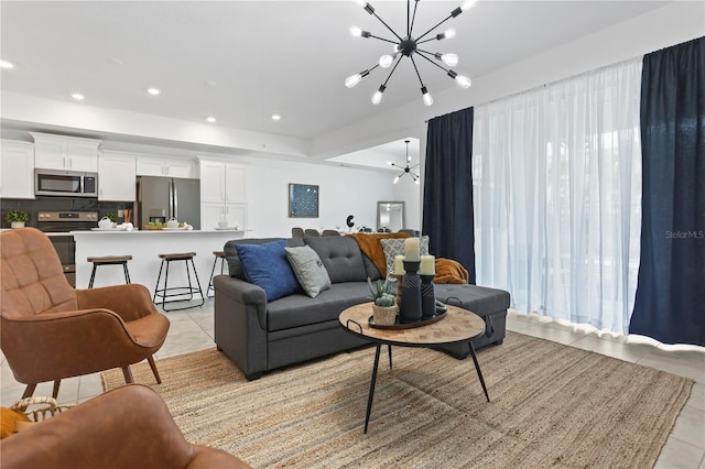 living area with light tile patterned floors, a chandelier, and recessed lighting