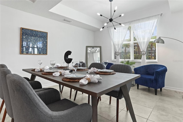 dining space with an inviting chandelier, light tile patterned floors, baseboards, and visible vents