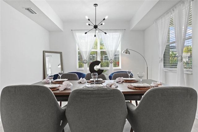 dining room featuring a chandelier and visible vents