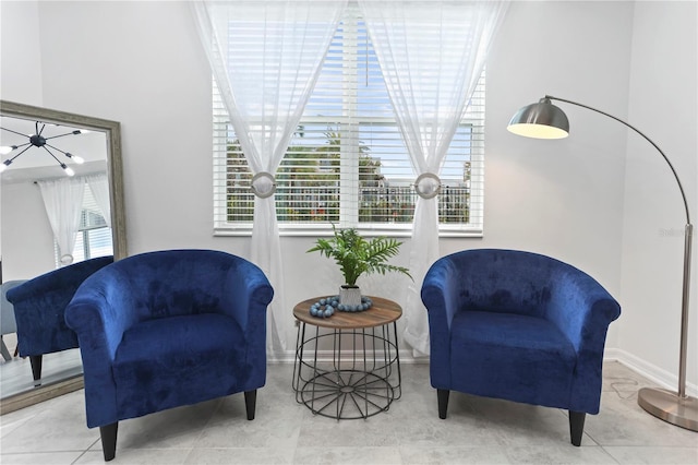 sitting room featuring baseboards, plenty of natural light, and tile patterned flooring