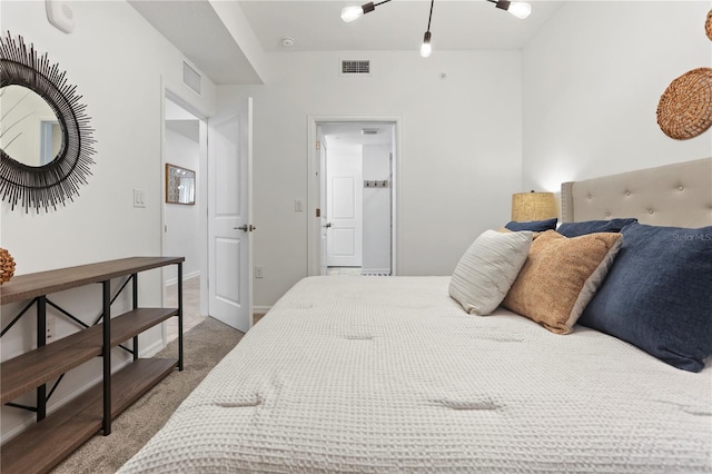 carpeted bedroom featuring visible vents and baseboards