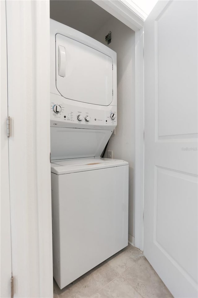 washroom featuring laundry area and stacked washer / drying machine