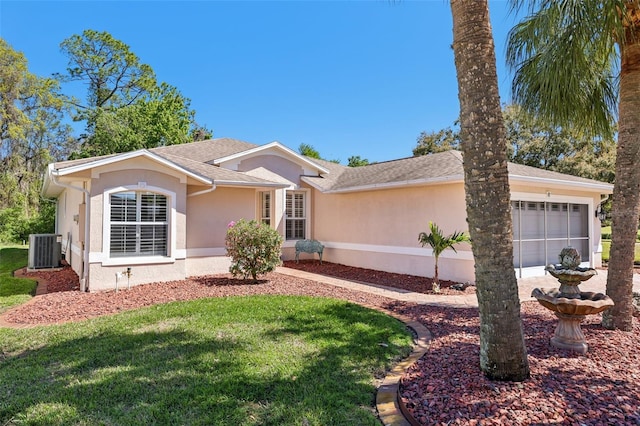 single story home featuring central air condition unit, stucco siding, a front yard, a shingled roof, and an attached garage