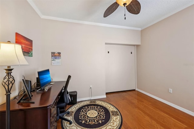 office area featuring ornamental molding, wood finished floors, baseboards, and ceiling fan