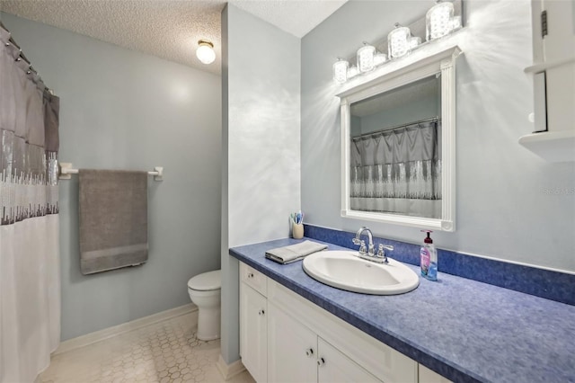 full bath with vanity, baseboards, a textured ceiling, tile patterned floors, and toilet