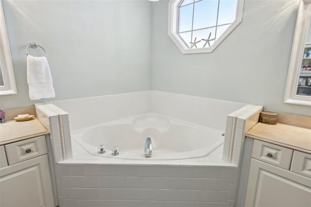 bathroom with a bath and vanity