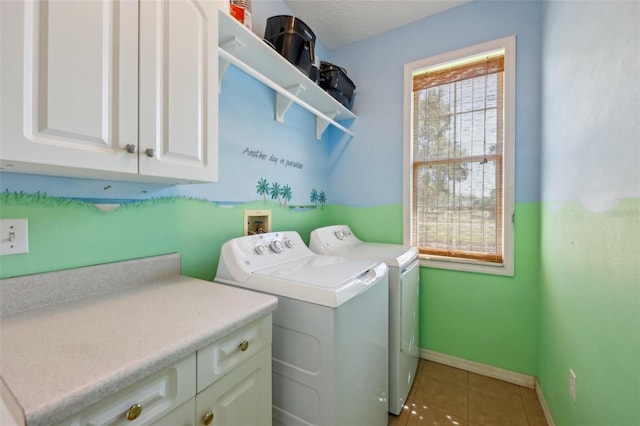 clothes washing area featuring baseboards, light tile patterned floors, cabinet space, a textured ceiling, and separate washer and dryer