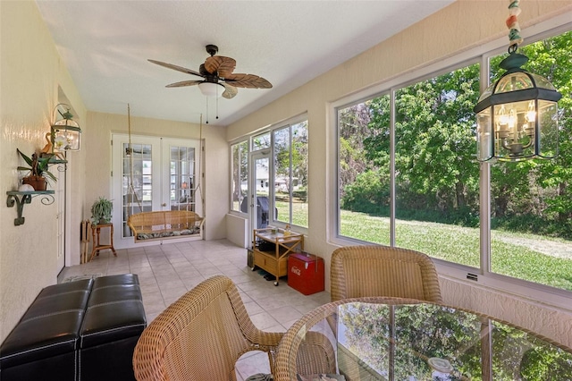 sunroom with ceiling fan with notable chandelier