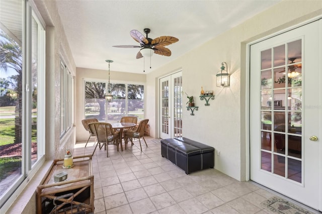 sunroom / solarium with french doors and a ceiling fan