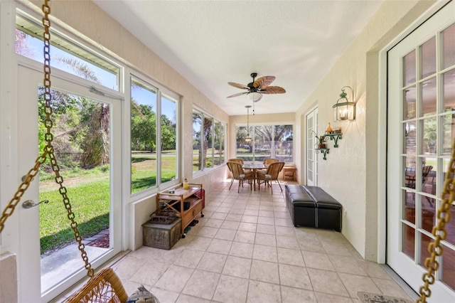 sunroom / solarium with a ceiling fan