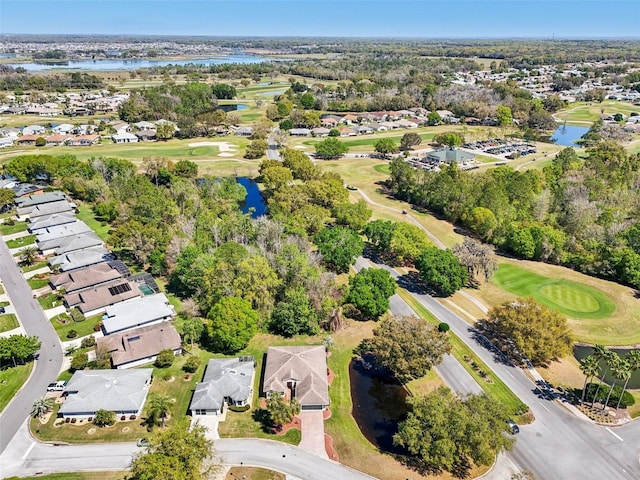 birds eye view of property with a residential view, a water view, and view of golf course