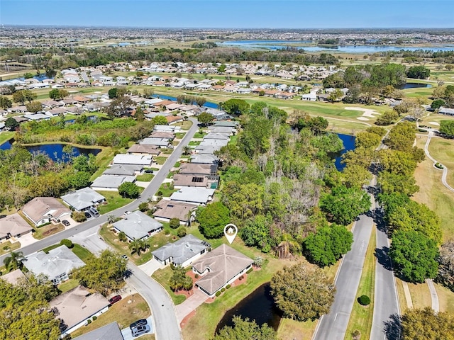 birds eye view of property featuring a water view and a residential view