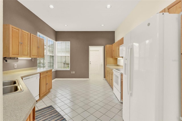 kitchen with a sink, recessed lighting, white appliances, light tile patterned flooring, and light countertops