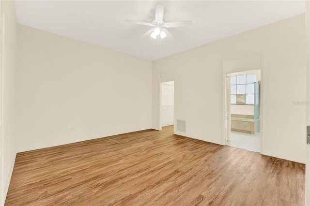 unfurnished room with visible vents, a ceiling fan, and light wood-type flooring