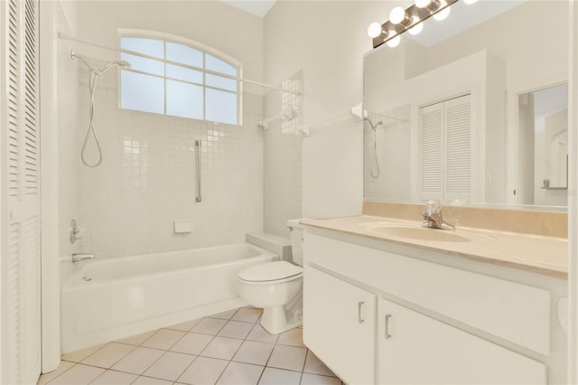 full bath featuring tile patterned flooring, toilet, bathing tub / shower combination, a closet, and vanity