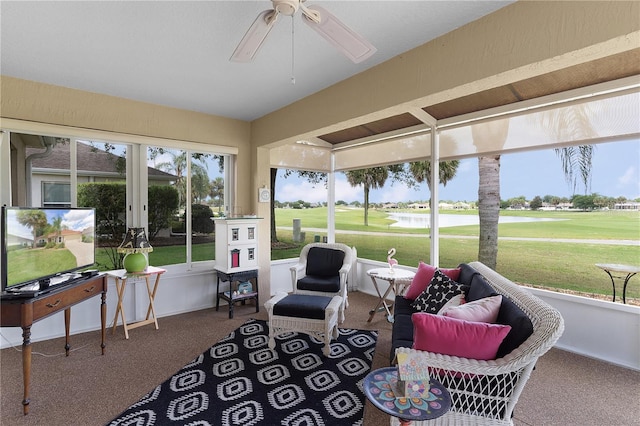 sunroom with plenty of natural light, french doors, a ceiling fan, and view of golf course