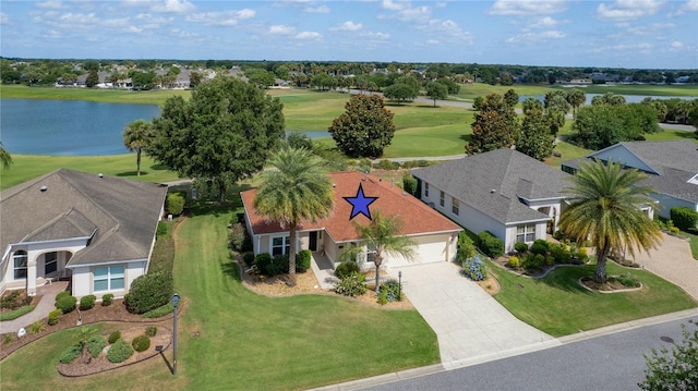 birds eye view of property with view of golf course and a water view