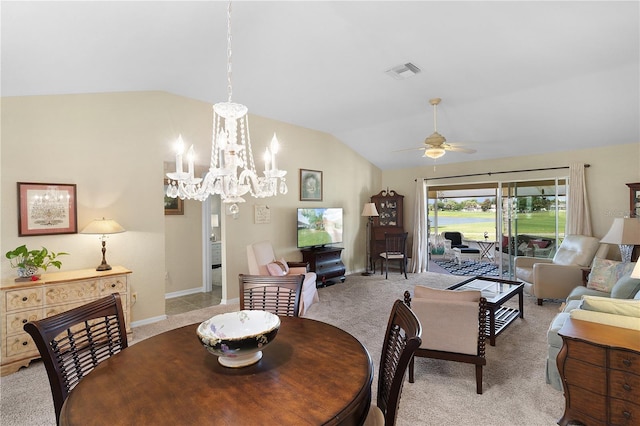 dining area featuring visible vents, baseboards, light colored carpet, lofted ceiling, and ceiling fan with notable chandelier