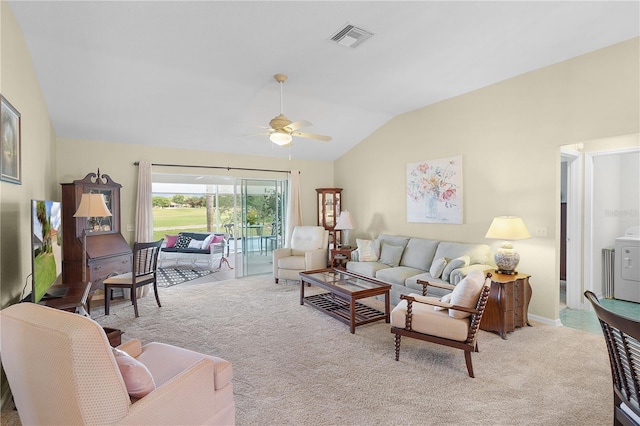 carpeted living area with lofted ceiling, a ceiling fan, visible vents, and washer / dryer