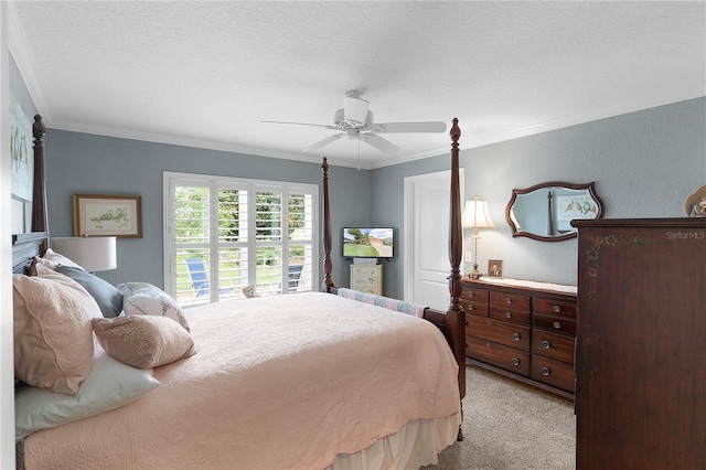 bedroom with a textured wall, ceiling fan, a textured ceiling, crown molding, and light colored carpet