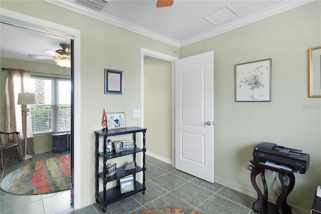 interior space with dark tile patterned floors, visible vents, crown molding, and baseboards