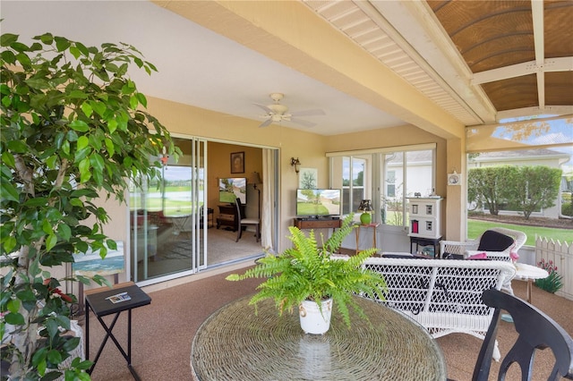 sunroom featuring a ceiling fan