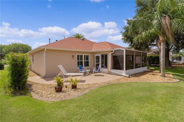 back of house with roof with shingles, stucco siding, a yard, a sunroom, and a patio area