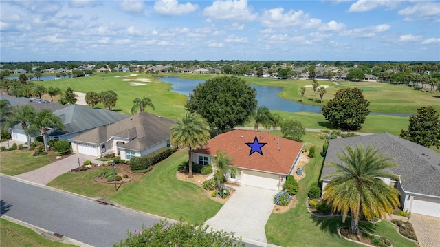 drone / aerial view with a water view and golf course view