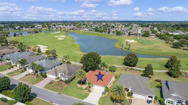 drone / aerial view with golf course view, a water view, and a residential view