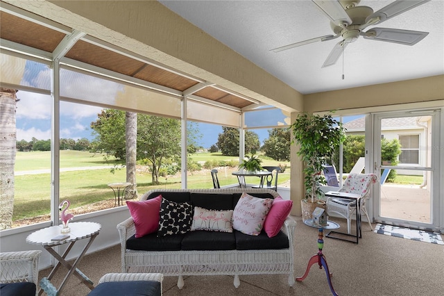 sunroom / solarium featuring ceiling fan