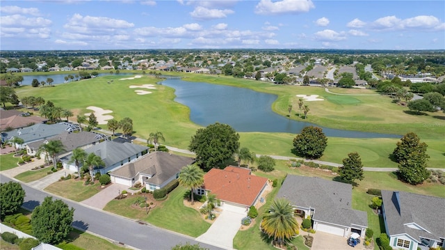 bird's eye view featuring golf course view, a water view, and a residential view