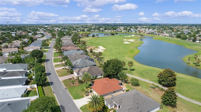 aerial view featuring a residential view, a water view, and view of golf course