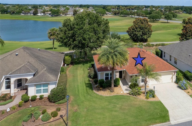 drone / aerial view with view of golf course and a water view