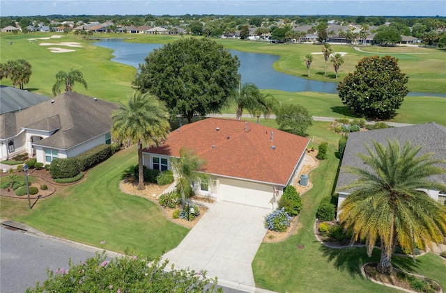 drone / aerial view featuring a residential view, view of golf course, and a water view