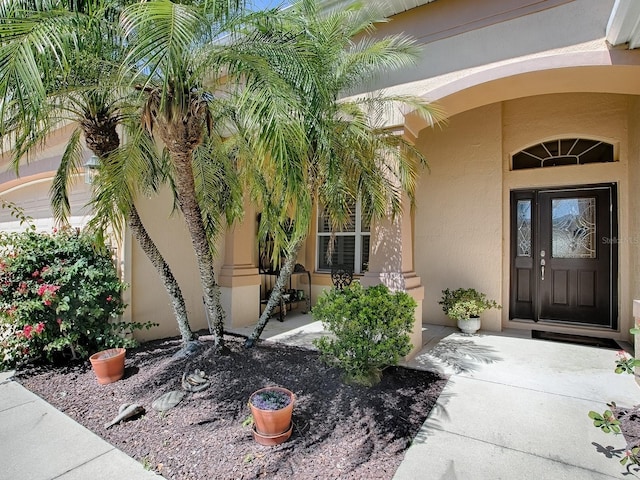 property entrance featuring stucco siding